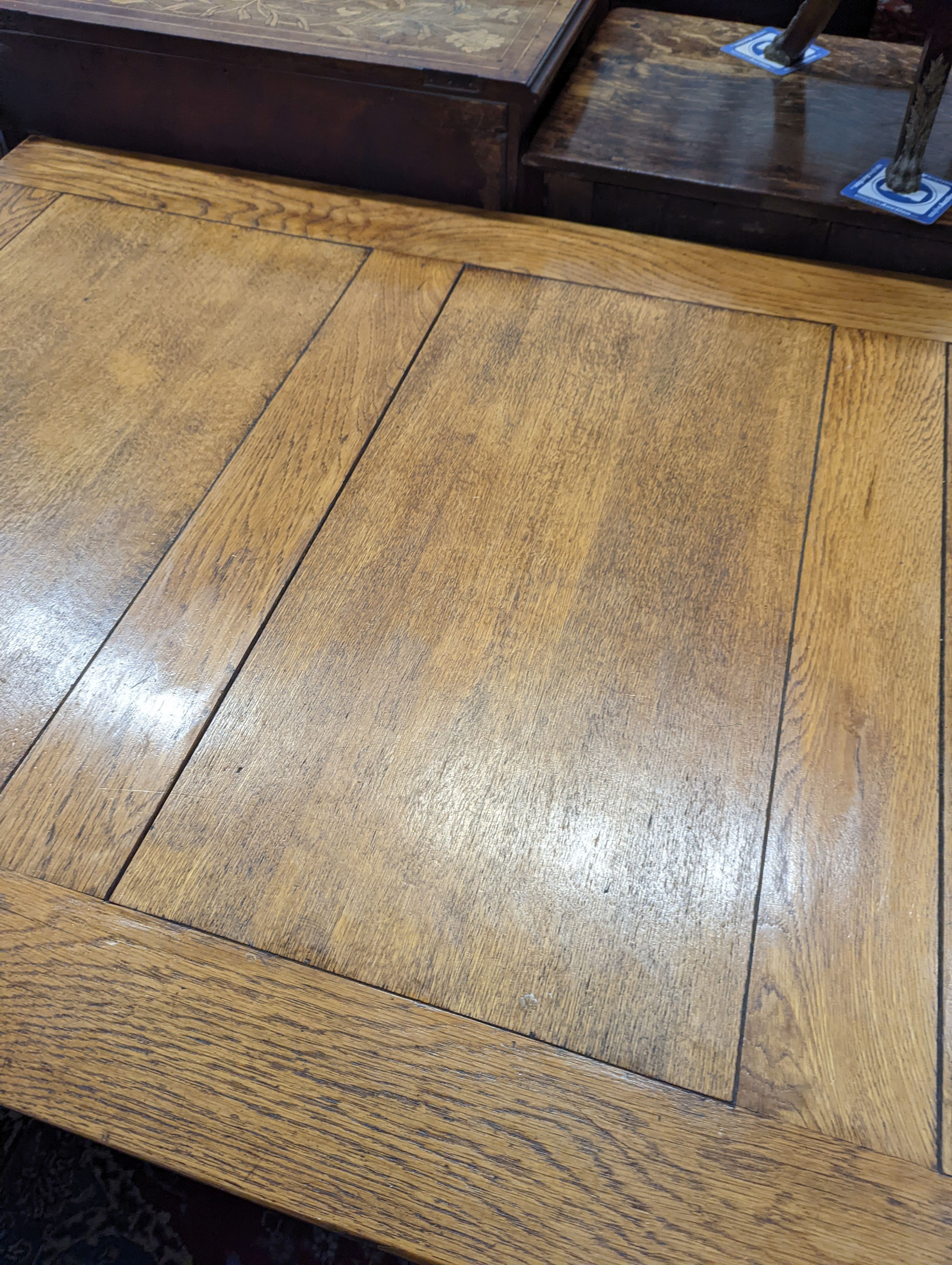 An 18th century style pale oak draw leaf dining table on carved baluster legs, length 242cm extended, depth 91cm, height 75cm